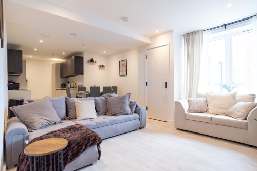 Bright open-plan living space with comfortable seating, dining area and fully equipped kitchen