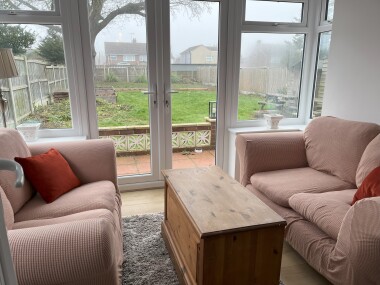 Bright conservatory overlooking the patio and garden. 