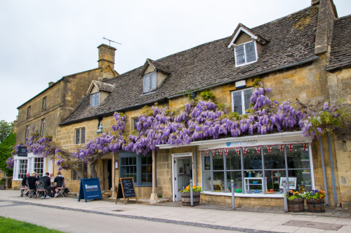 Beautiful Broadway village High Street with Wysteria