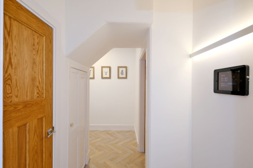 Spacious Hallway with Walk-in cupboard housing dining and outdoor chairs, washing machine and supplies.  Secondary cupboard gives some storage as well as housing supplies including high chair