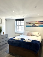 Beautiful large bedroom with stunning natural light, smart TV, desk with ergonomic chair, on-suite bathroom with walk in shower, lamp, built in wardrobe, chest of draws and everything else you need for a perfect stay!