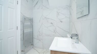 A fresh, modern, fitted bathroom, with a walk in shower. Toiletries and  hotel style towels provided.