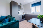 Spacious living room with comfortable seating and inviting atmosphere, perfect for relaxing or socialising during your stay.