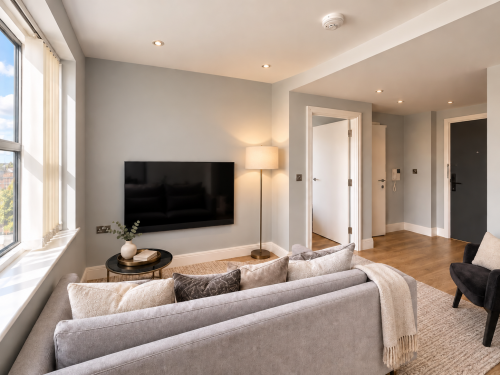 Living and dining area
Bright, contemporary living space featuring comfortable seating, warm wood flooring and a compact dining area beside large windows offering abundant natural light.