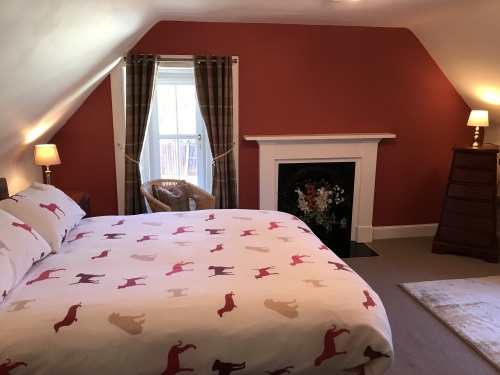 This King Size Room has dual aspect windows and an attractive old fireplace