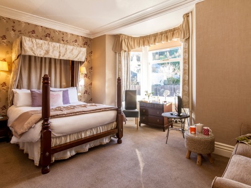 Relax in our bright four poster room