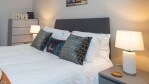 Comfortable king size bed with hotel style linens