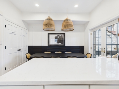 Sink into soft seating framed by bold accents and natural light.