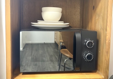 In each room: Microwave, plates, bowls, cutlery, tea, coffee, sugar, biscuits, kettle, mugs, drinking glasses