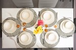 Dining area for 8 guests with brand new dining table chair set and crockery sets