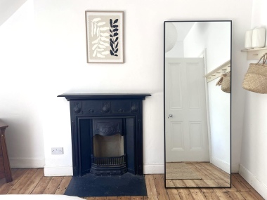 Characterful bedroom with original fireplace and full-length mirror