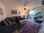 lounge area with large patio windows with sea views 