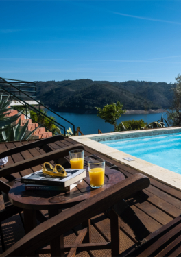 Swimming pool with deck, sun loungers and stunning views.