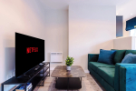 Spacious living room with comfortable seating and inviting atmosphere, perfect for relaxing or socialising during your stay.