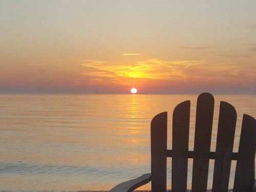 Adirondack chairs on the beach