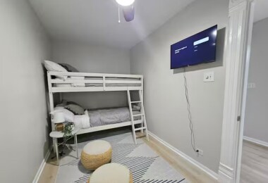 This cozy room features a twin bunk bed and a 32-inch TV, perfect for kids' slumber parties or separate sleeping arrangements. The comfortable setup and playful decor make it an ideal space for younger guests to relax and enjoy their stay.