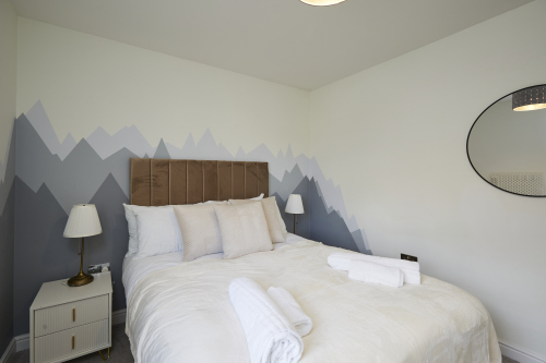 Well-appointed bedroom with natural light and modern comforts.