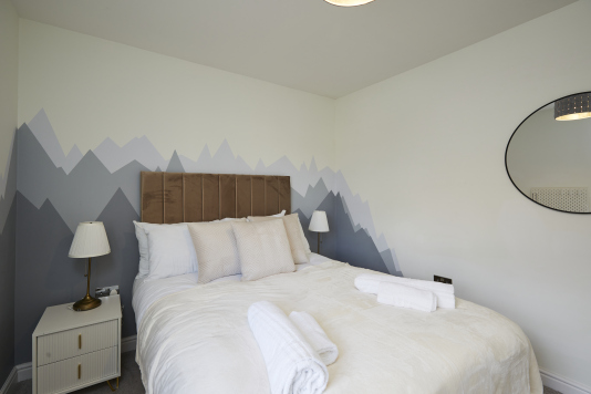 Well-appointed bedroom with natural light and modern comforts.