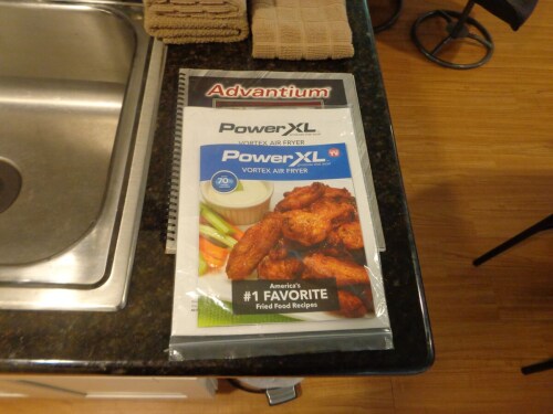 GE Advantium oven, Induction cooking surface, and Air Fryer with instruction manuals