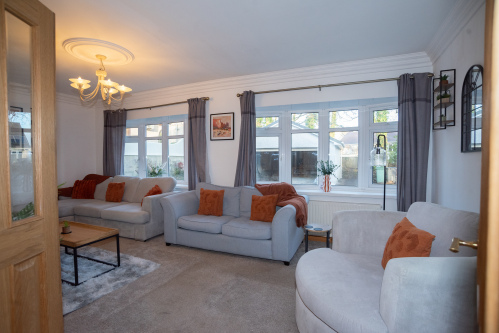 Spacious lounge area with plenty of comfortable seating, offering room for everyone to relax and spend time together.