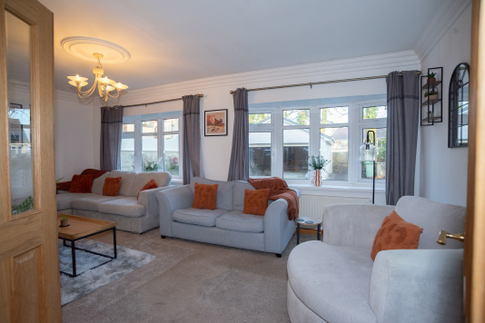 Spacious lounge area with plenty of comfortable seating, offering room for everyone to relax and spend time together.