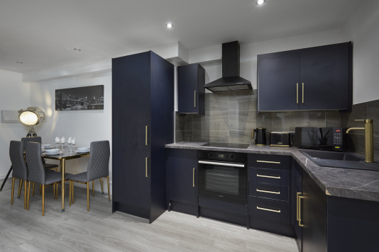 Well-appointed kitchen with essential appliances and ample workspace.