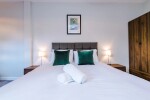 Comfortable bedroom with a king-size zip and link bed that can be separated into two singles upon request.