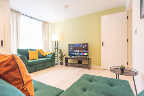 Bright comfortable lounge with Smart TV, perfect for relaxing after a day exploring.