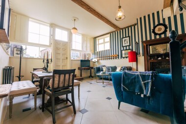 the living room with its double height ceiling and cabouchon tiles