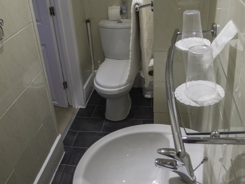 Bathroom in room with king size bed