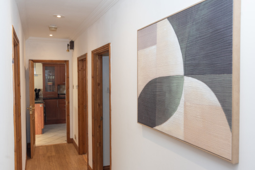 Ground-floor hallway connecting the kitchen and living spaces, with bedrooms on the same level providing flexible sleeping options.