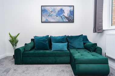 Plush sofa bed fully dressed with fresh linens and ready to go — offering extra comfort and flexible sleeping space in the cosy living room.