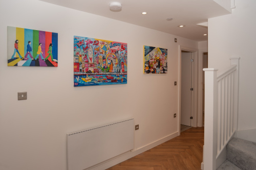 A beautiful, spacious entranceway with welcoming artwork, offering accessible space ideal for contractors or larger group stays of up to 10 guests.