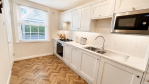 Fully fitted kitchen with dishwasher, oven, fridge freezer, microwave and washing machine.