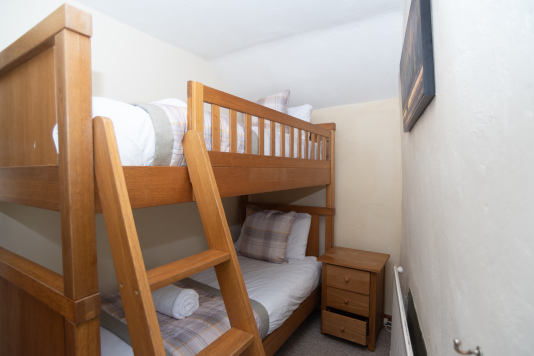 Ideal for children, the bunk bedroom provides a fun and comfortable sleeping space within this traditional cottage.