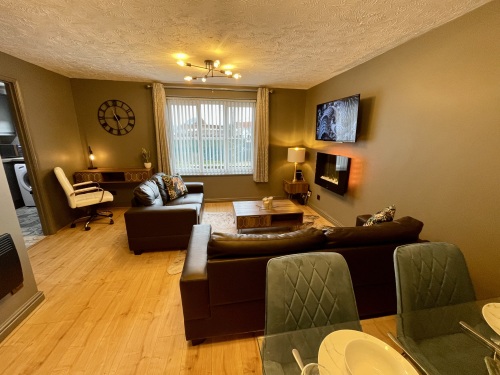 Open plan living area with flat screen TV and fireplace