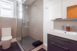Spacious stylish bathroom with large rainfall shower