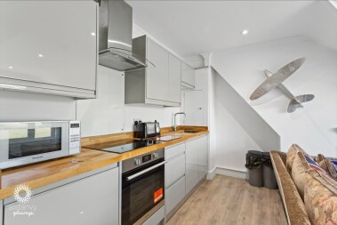 Grey gloss kitchen with fitted oven and fridge freezer