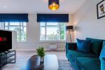 Spacious living room with comfortable seating and inviting atmosphere, perfect for relaxing or socialising during your stay.