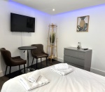 Beautiful large bedroom with stunning natural light, gorgeous artwork, smart TV, desk with comfy chairs, lamp, wardrobe, chest of draws and everything else you need for a perfect stay!