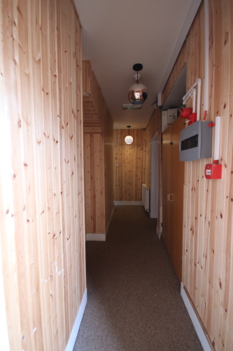 Inside communal door, stairs at the end