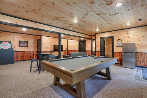 25-Lower level rec room including an extra refrigerator and game table