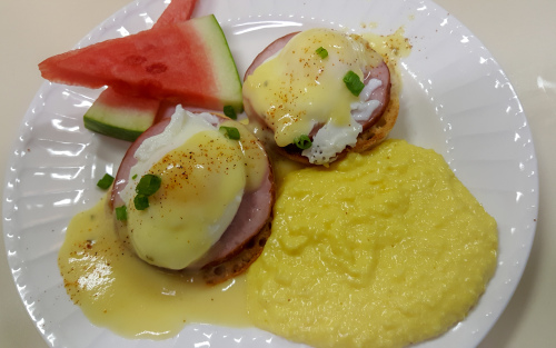 Egg Benedict served with Sour Cream Grits