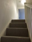 Stairs with banister to upper floor
