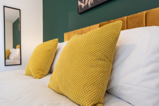 Comfortable king bed with premium bedding, configurable as two singles if needed.