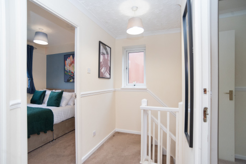 A large, airy open landing leading to three bedrooms, including one with an en suite shower room, plus a master bathroom with a bath.