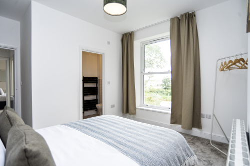 Bright Double En Suite Bedroom — Fresh linens, modern décor and your own private bathroom