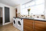 Spacious kitchen with washer and dryer