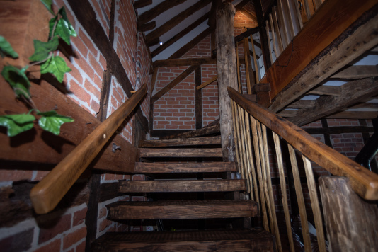 Beautiful handcrafted staircase adding unique charm and true treehouse-style character to the cottage