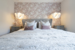 Experience elevated living with this beautifully appointed master bedroom.